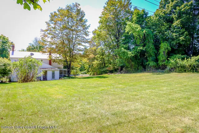 a living room with furniture a fireplace and a window