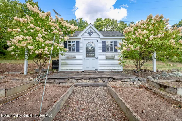 a living room with furniture and a book shelf
