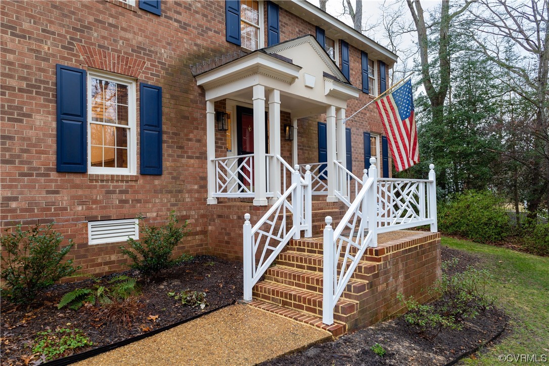 8949 Cardiff Road North Chesterfield, VA 23236 - Photo 42 of 49 a view of a white house with large windows and a small yard