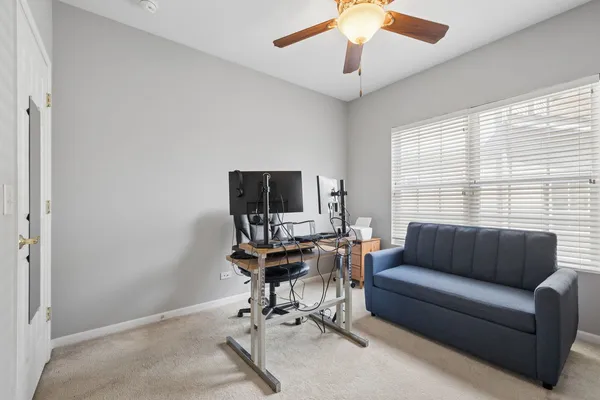 a view of a livingroom with workspace and a window