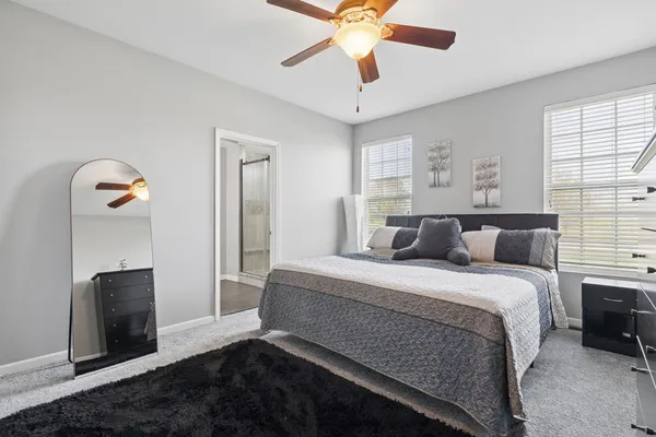 a bedroom with a bed and a chandelier