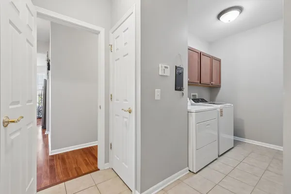a view of a storage & utility room with cabinets