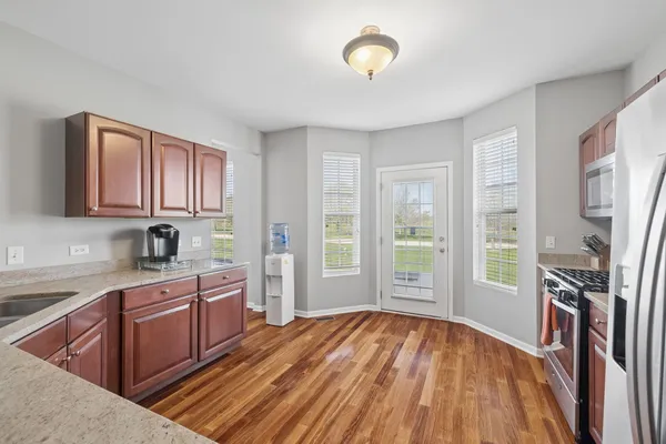 a view of a kitchen with a sink cabinets and wooden floor