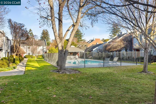 a view of a swimming pool in front of residential houses