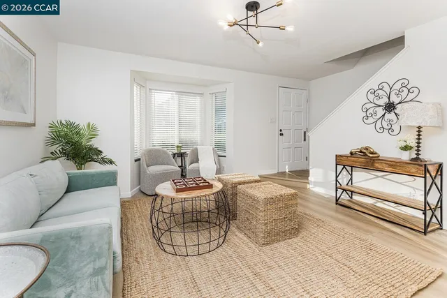 a living room with furniture and white walls