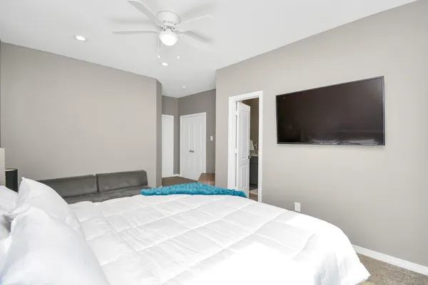 a bedroom with a bed and a flat screen tv