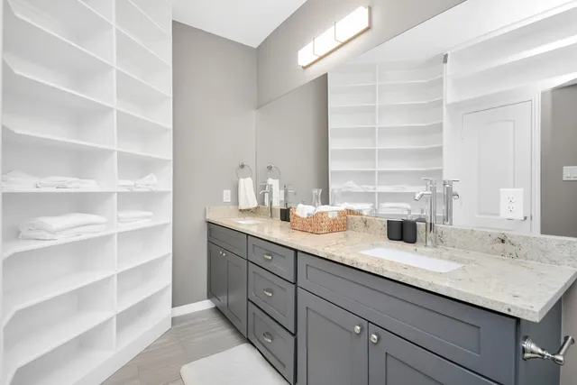 a bathroom with a granite countertop sink mirror and
