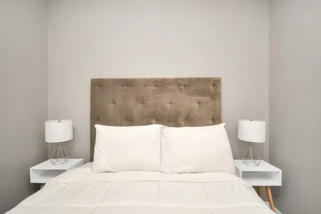 a large white bed in a white room