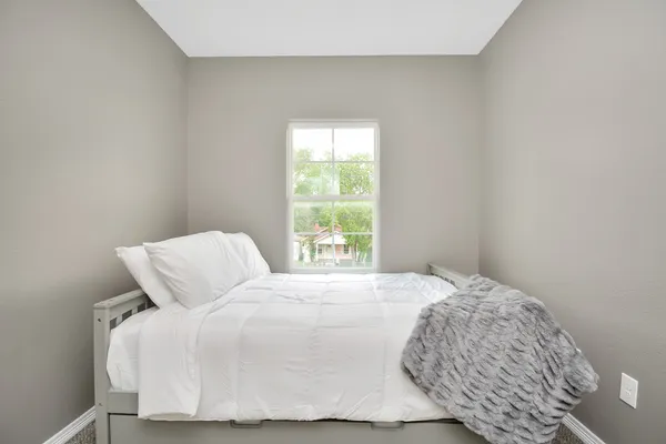 a bedroom with a bed and window