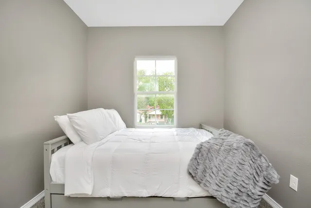 a bedroom with a bed and window