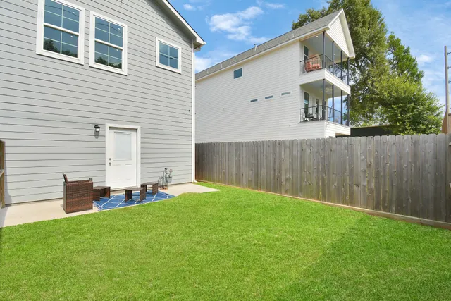 a backyard of a house with table and chairs