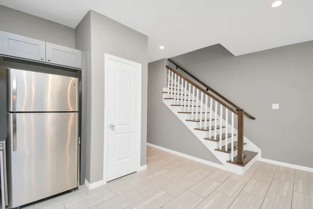 a view of a hallway with wooden floor and entryway