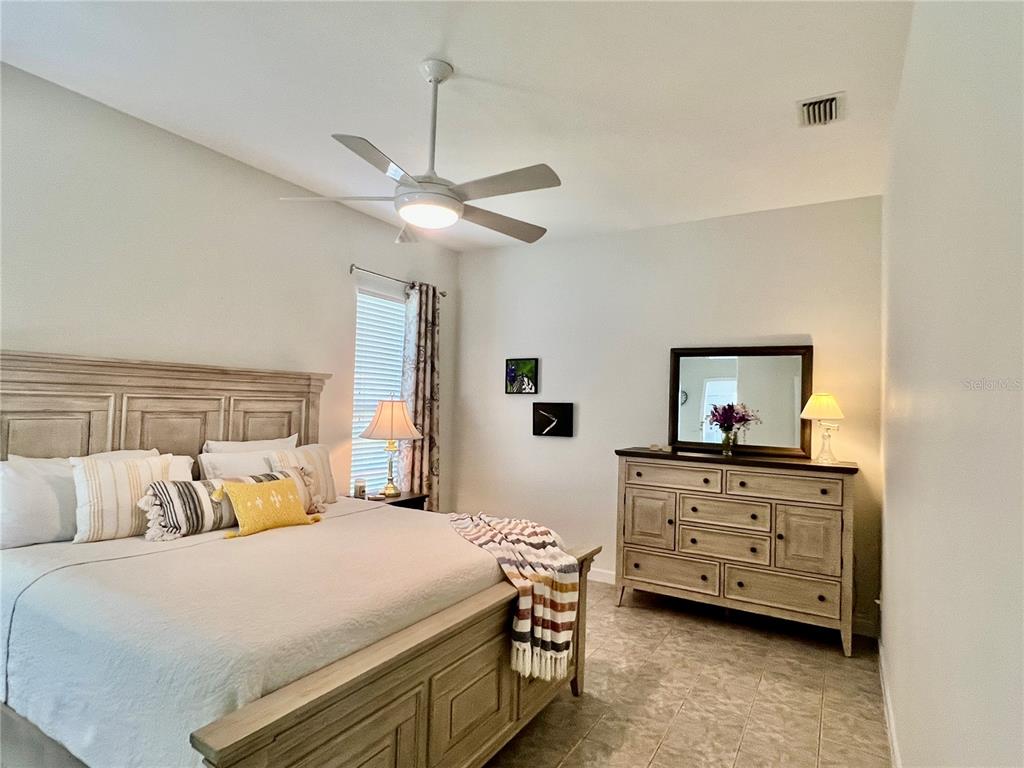 2515 Northwest 53rd Avenue Road Ocala, FL 34482 - Photo 34 of 94 a bedroom with a bed and a chandelier