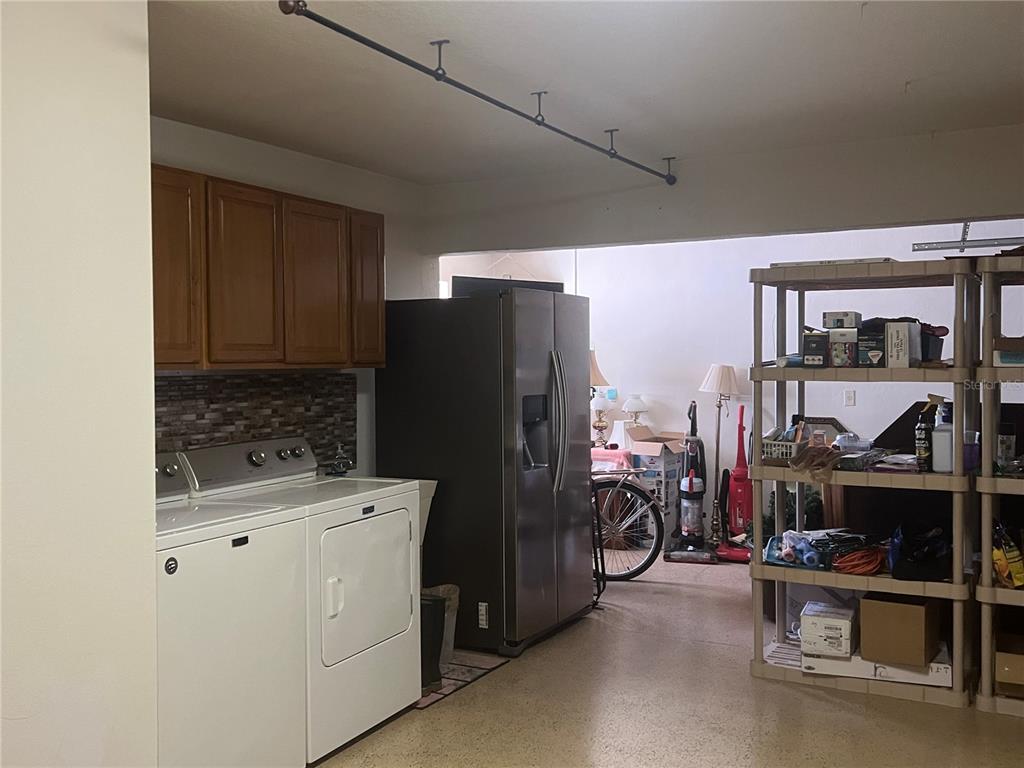 2515 Northwest 53rd Avenue Road Ocala, FL 34482 - Photo 63 of 94 a kitchen with a refrigerator and a stove top oven
