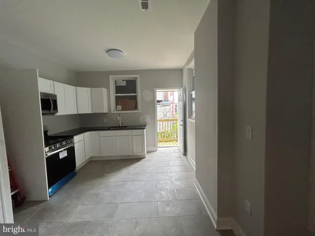 a large kitchen with cabinets and stainless steel appliances