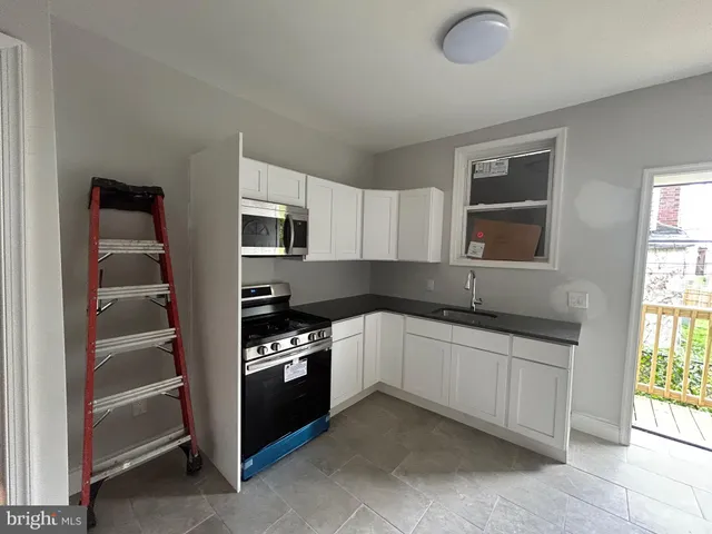 a kitchen with stainless steel appliances granite countertop a stove and a sink