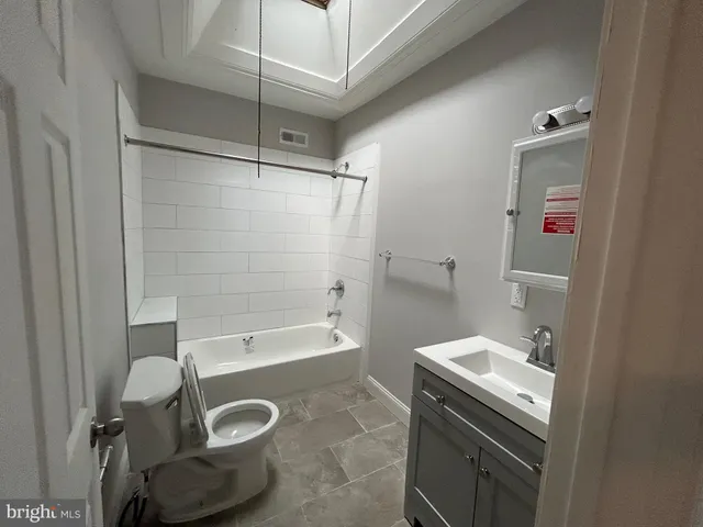 a bathroom with a sink a toilet and bathtub