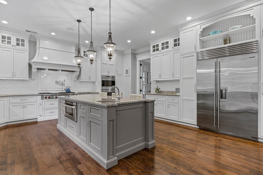 3 Ravine Road Winchester, MA 01890 - Photo 13 of 42 a kitchen with stainless steel appliances granite countertop a sink a stove and a refrigerator