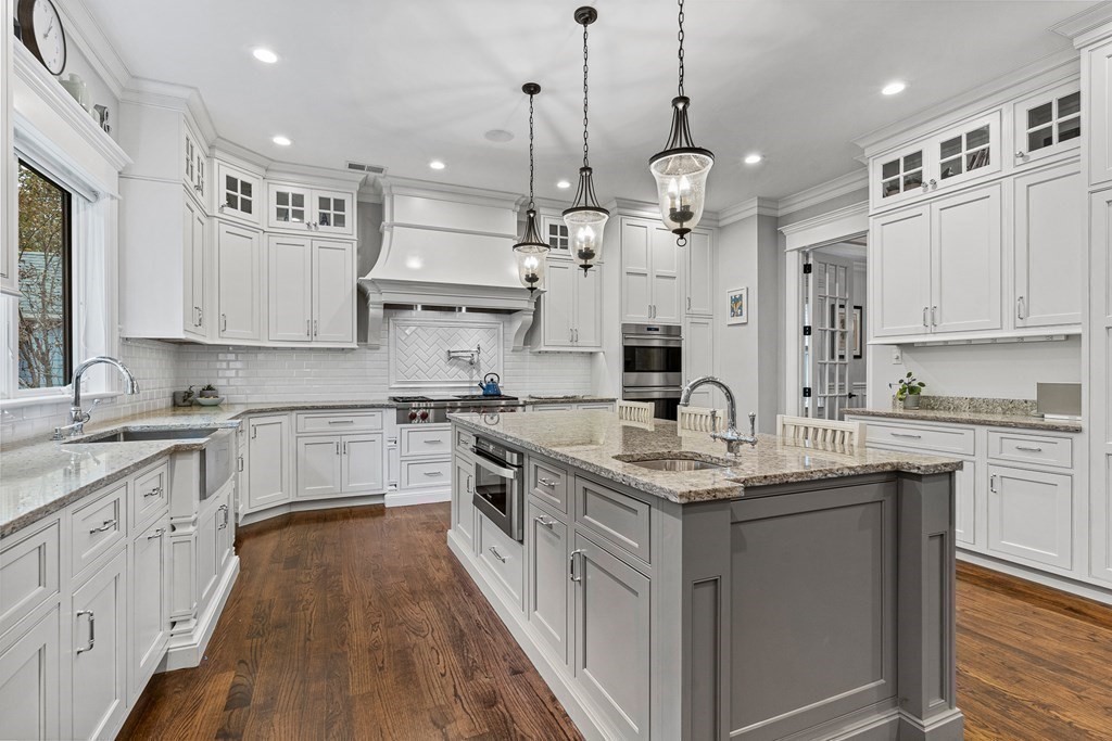 3 Ravine Road Winchester, MA 01890 - Photo 16 of 42 a kitchen with kitchen island granite countertop a sink a counter space appliances and cabinets