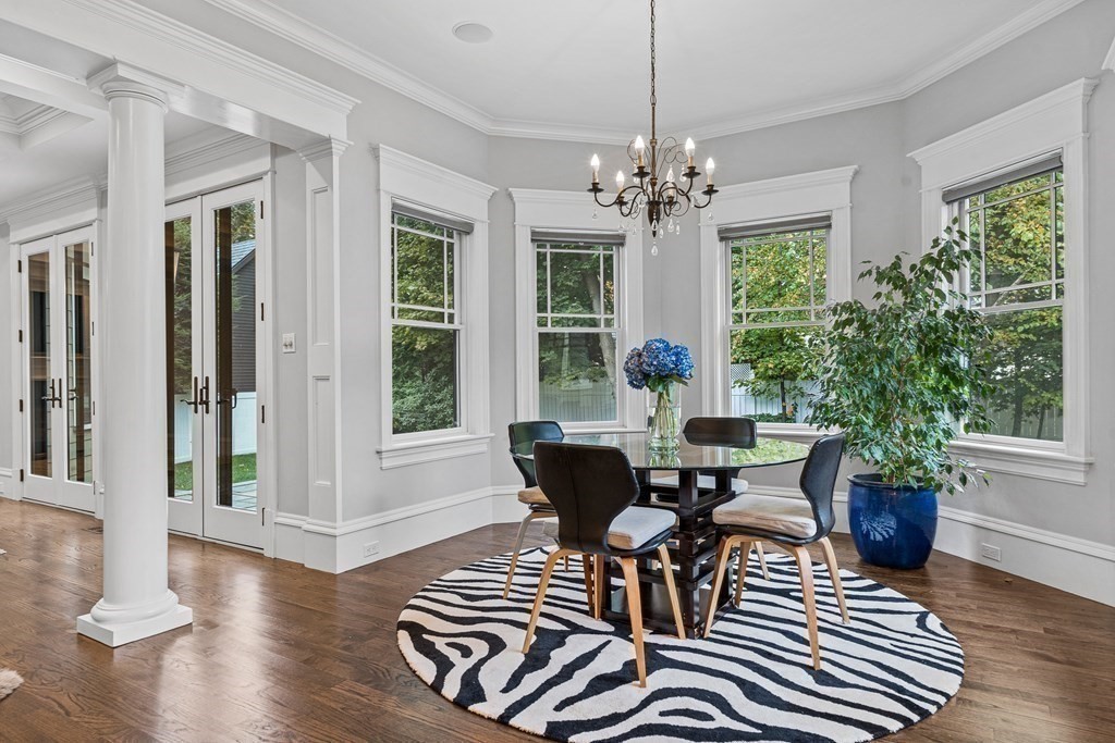 3 Ravine Road Winchester, MA 01890 - Photo 20 of 42 a dining room with wooden floor a chandelier a glass table and chairs