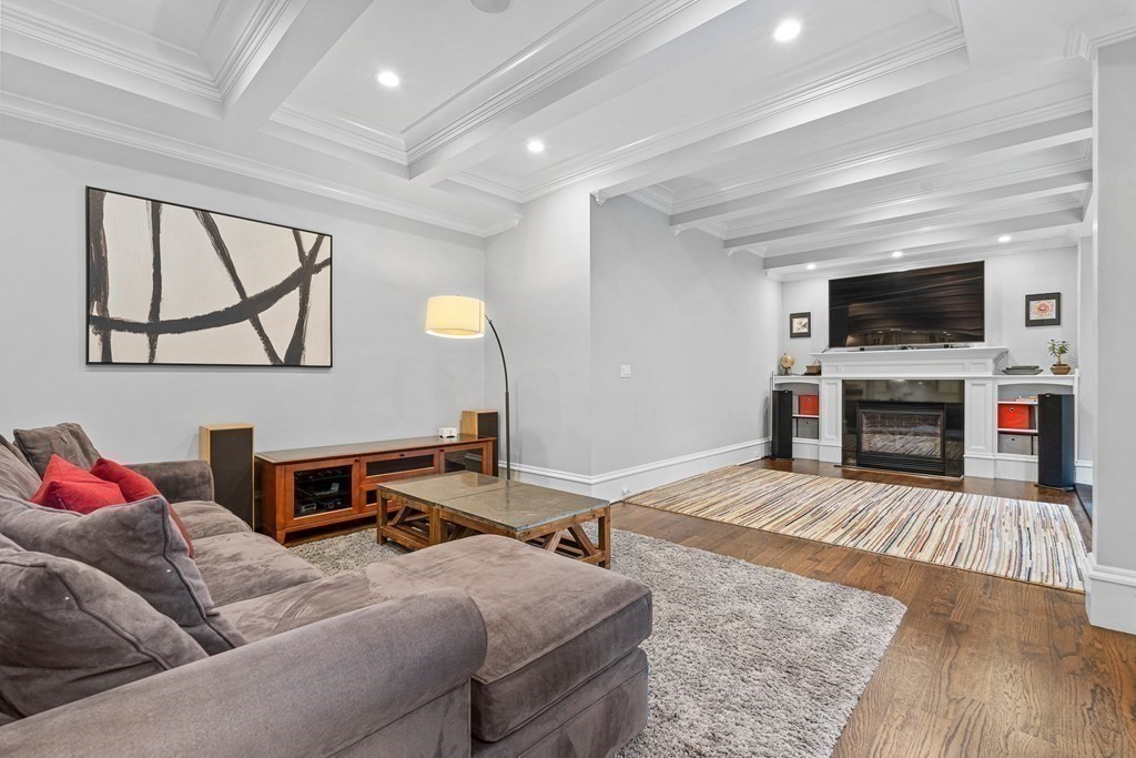 3 Ravine Road Winchester, MA 01890 - Photo 22 of 42 a living room with furniture a flat screen tv and a fireplace