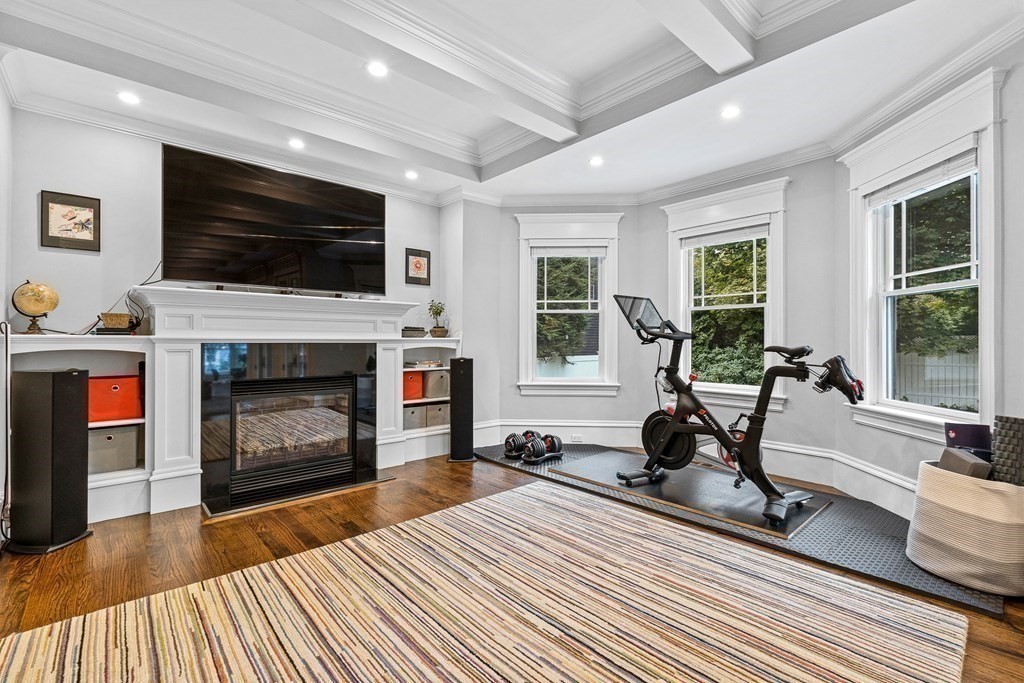 3 Ravine Road Winchester, MA 01890 - Photo 23 of 42 a living room with furniture a flat screen tv and a fireplace