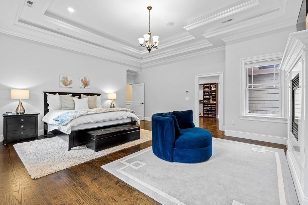 3 Ravine Road Winchester, MA 01890 - Photo 27 of 42 a bedroom with a bed lamp and a chandelier