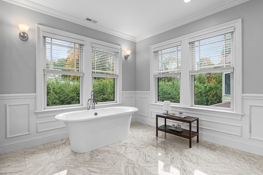 3 Ravine Road Winchester, MA 01890 - Photo 33 of 42 a white bath tub sitting in a bathroom next to a window