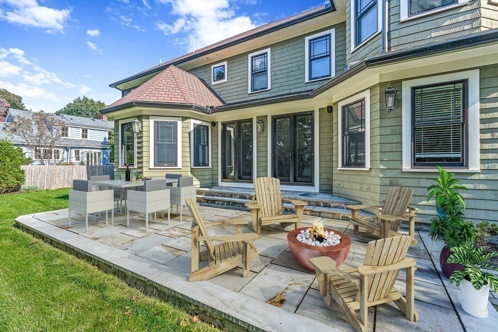 3 Ravine Road Winchester, MA 01890 - Photo 4 of 42 a view of a patio with table and chairs potted plants and floor to ceiling window