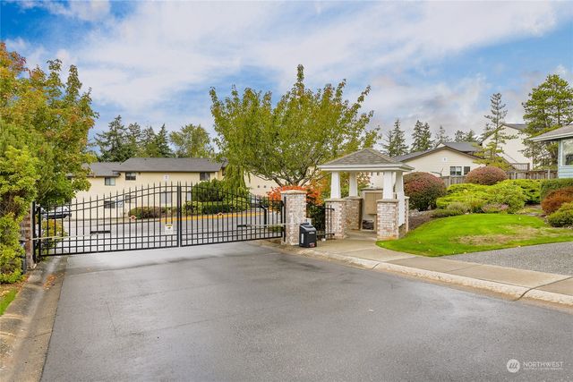 a view of a house with a small yard and potted plants