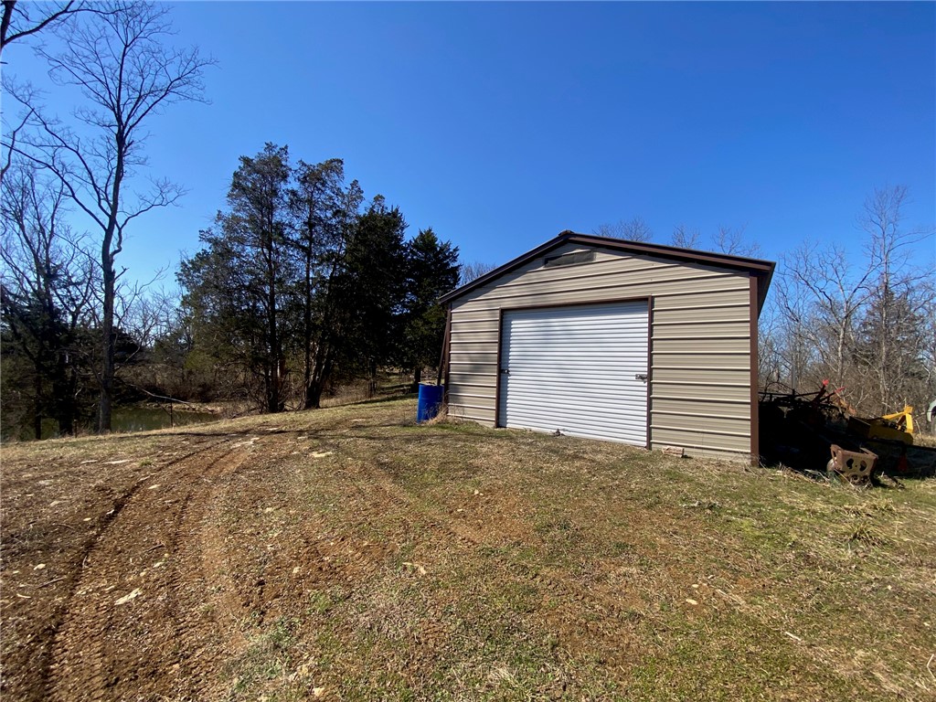 43 Old State Road Manchester, OH 45144 - Photo 1 of 11 This metal outbuilding offers practical storage solutions with a spacious roll-up door.