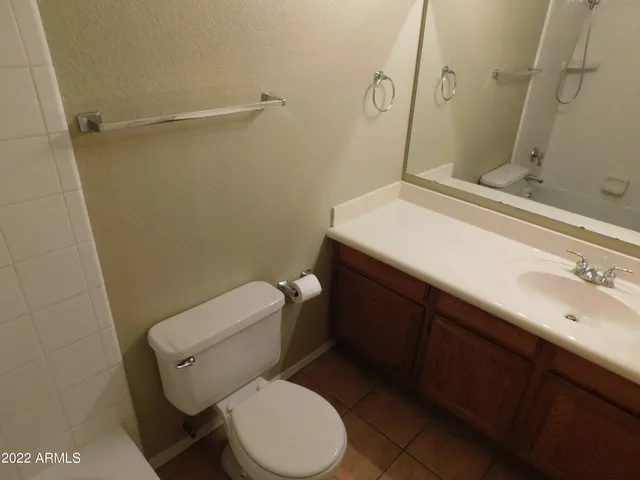 a white toilet sitting next to a bathroom sink