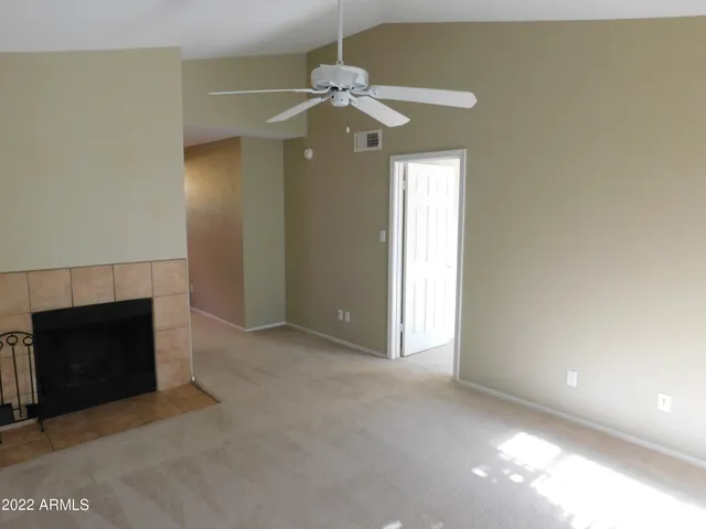 a view of a livingroom with a fireplace and fan