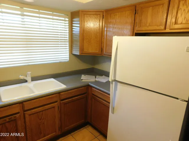 a kitchen with a refrigerator and a sink