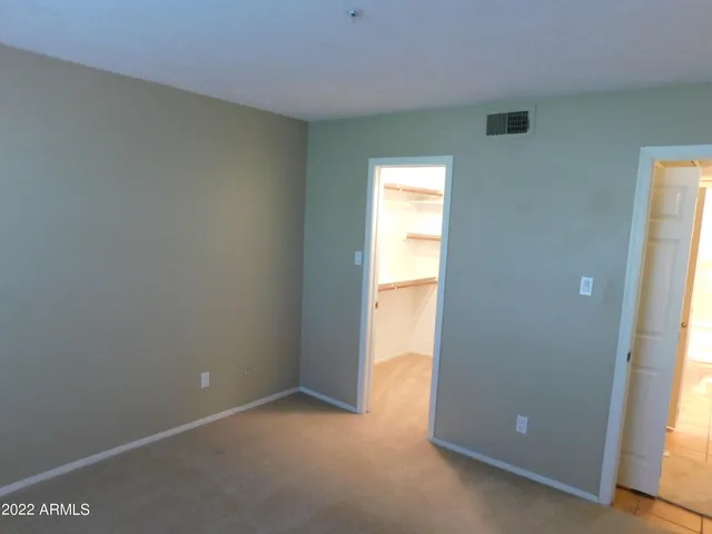 a view of an empty room and a window