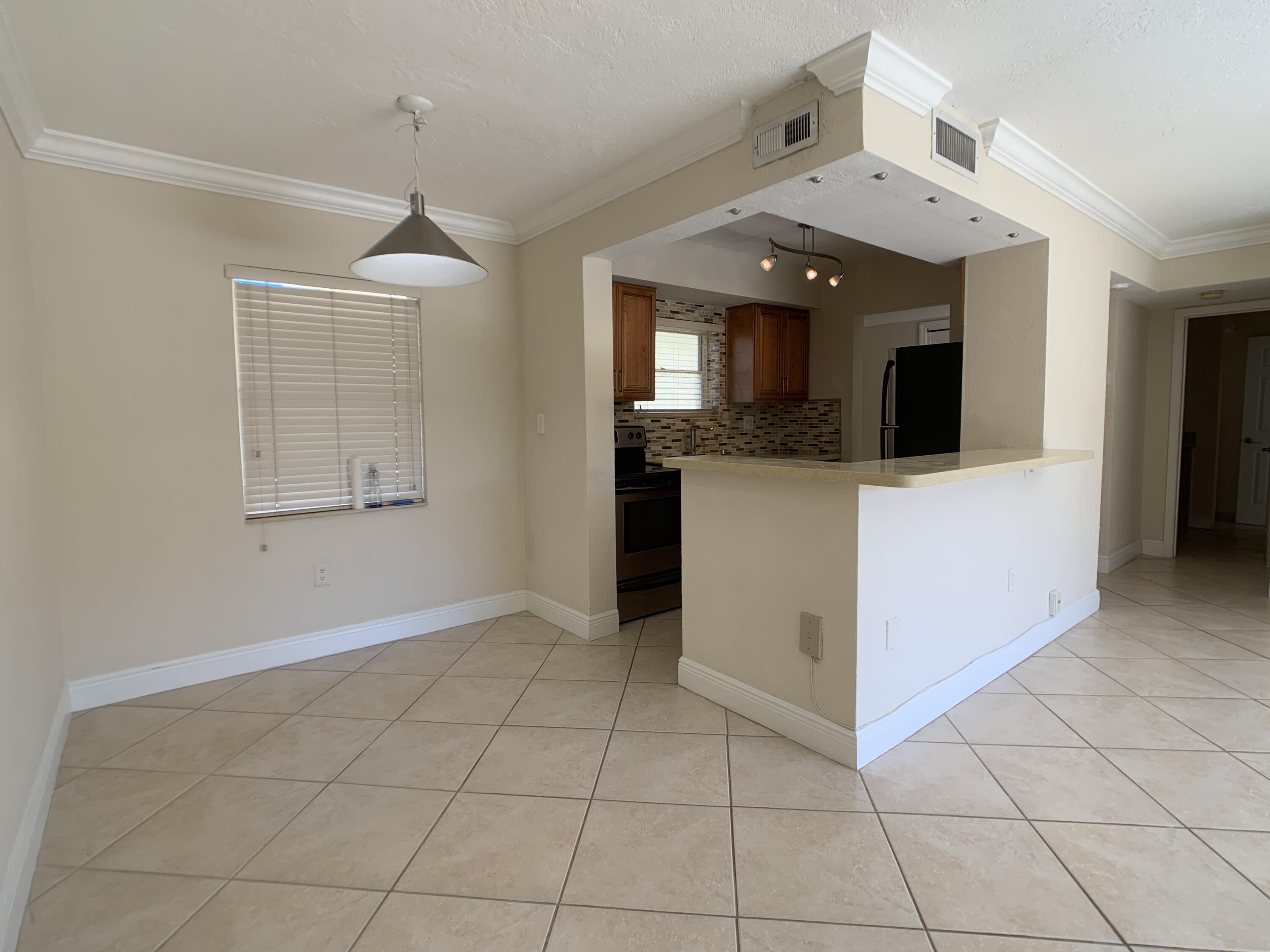 8601 Southwest 94th Street, Unit 201W Miami, FL 33156 - Photo 5 of 14 wooden floor in an empty room with a kitchen