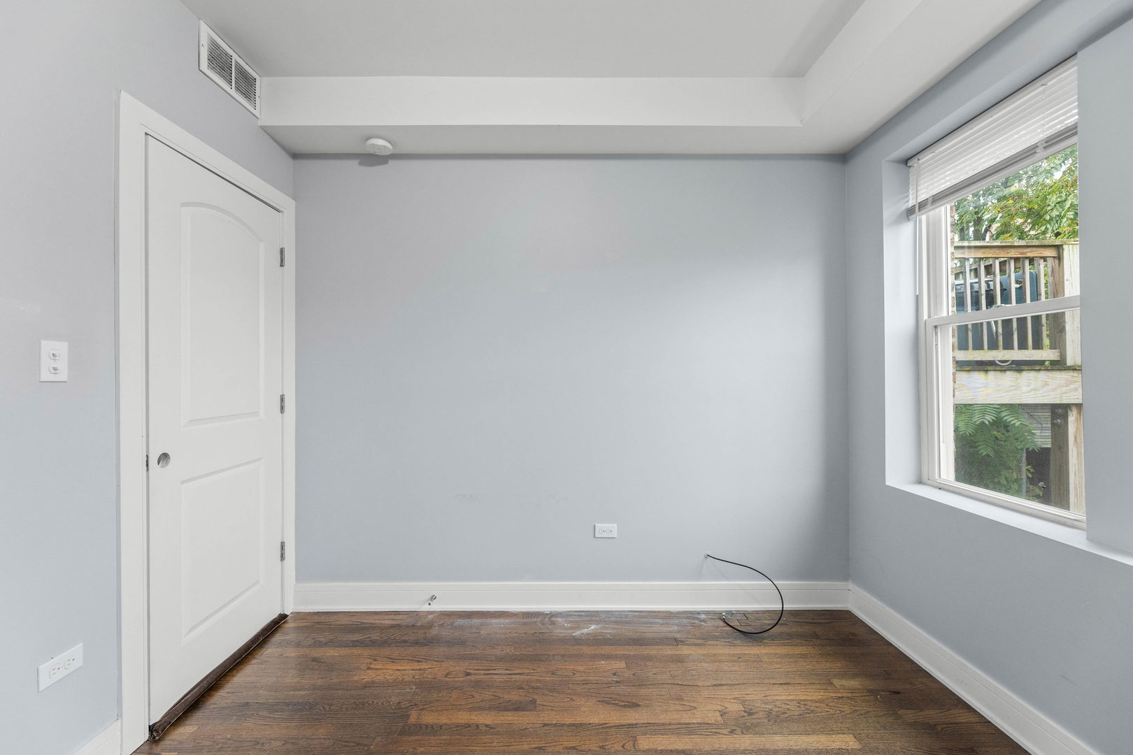 7752 South Wood Street, Unit 1 Chicago, IL 60620 - Photo 11 of 12 a view of an empty room with wooden floor and a window