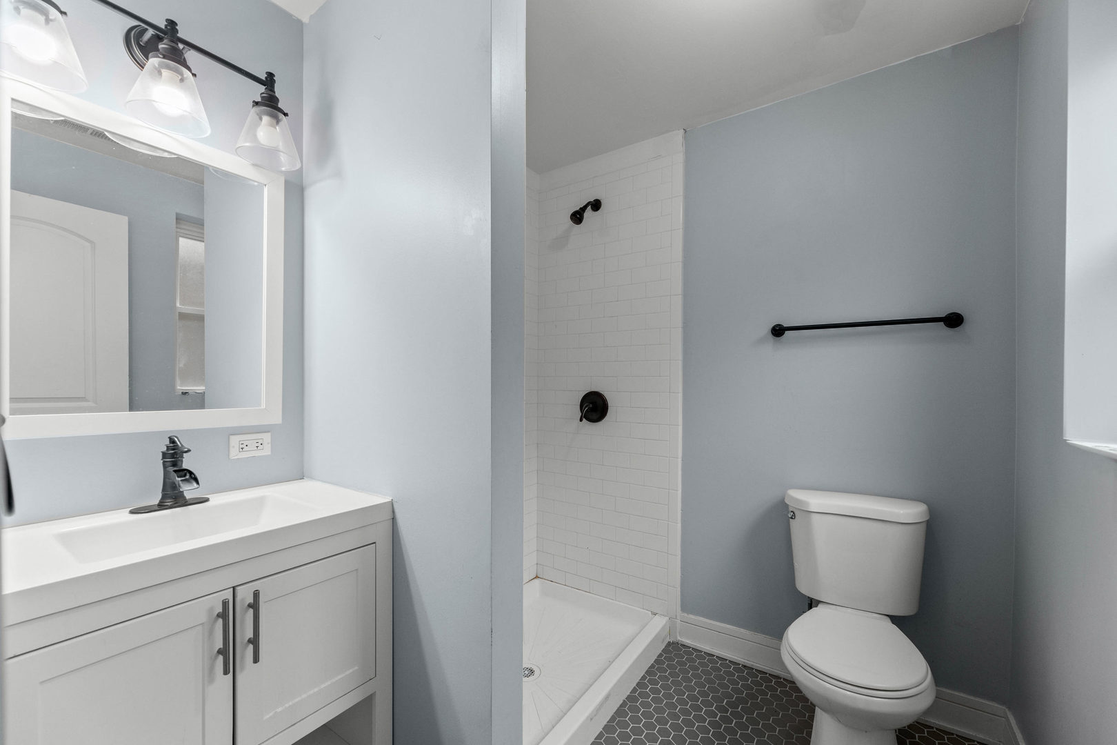 7752 South Wood Street, Unit 1 Chicago, IL 60620 - Photo 6 of 12 a bathroom with a toilet sink and mirror