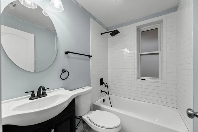 a bathroom with a sink toilet a mirror and shower