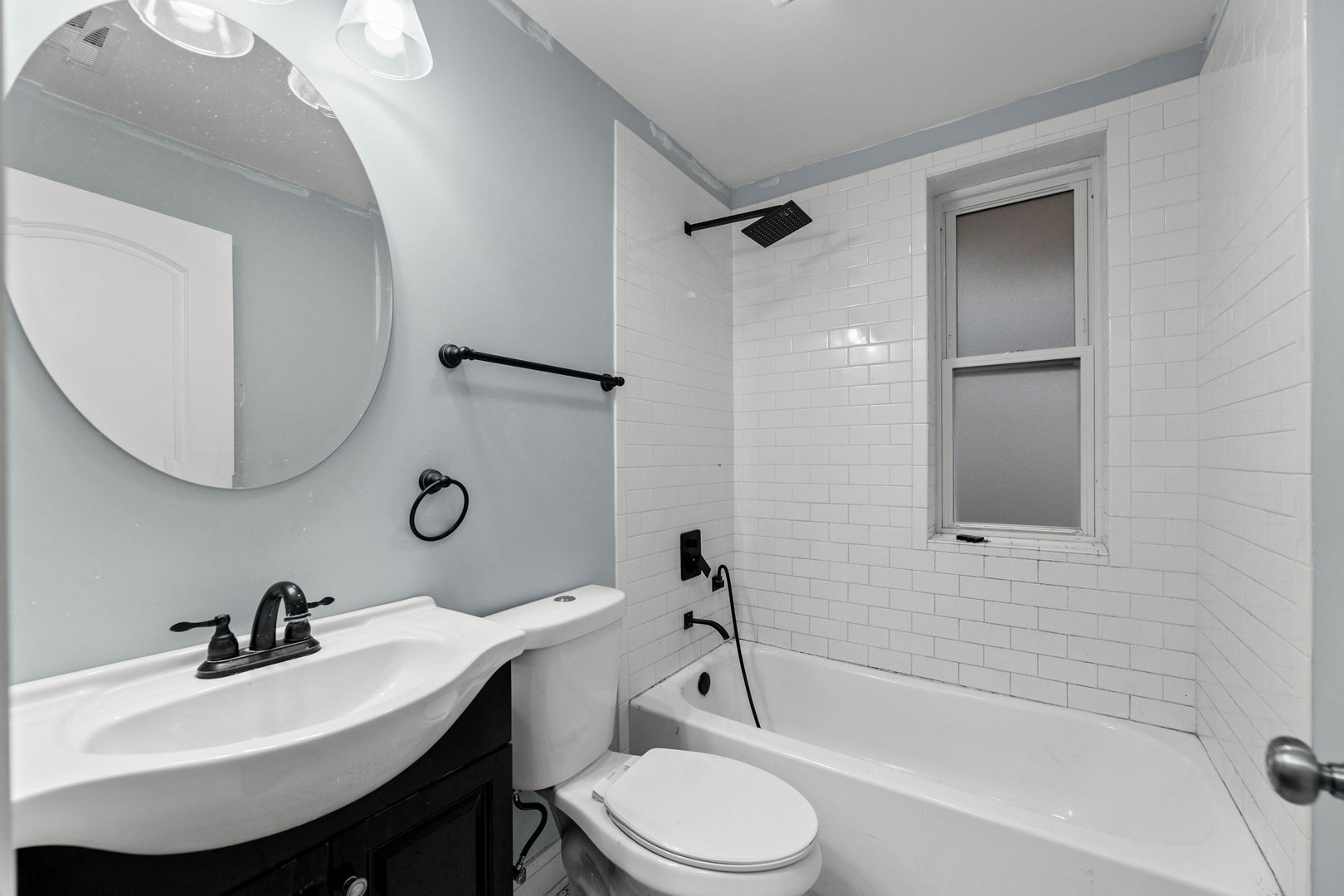 7752 South Wood Street, Unit 1 Chicago, IL 60620 - Photo 9 of 12 a bathroom with a sink toilet a mirror and shower
