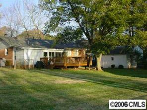 4100 Woodleaf Road Charlotte, NC 28205 - Photo 2 of 8 a view of a house with a big yard and large trees