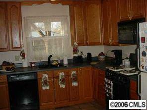 4100 Woodleaf Road Charlotte, NC 28205 - Photo 3 of 8 a kitchen with a sink a stove and cabinets