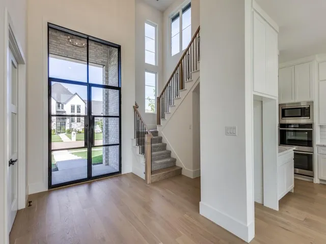 a view of entryway and hall with wooden floor