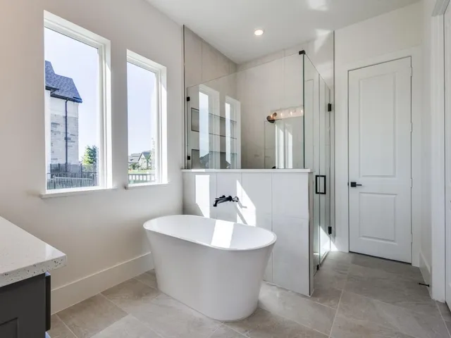 a bathroom with a bathtub and shower