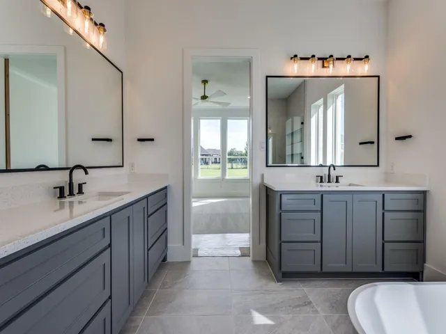 a bathroom with a double vanity sink mirror and double