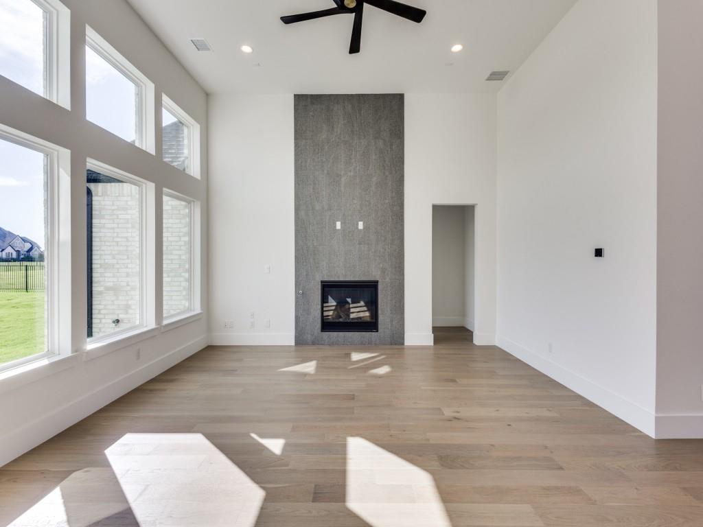 1045 Bent Tree Lane Gunter, TX 75058 - Photo 9 of 25 a view of an empty room with a window and kitchen view