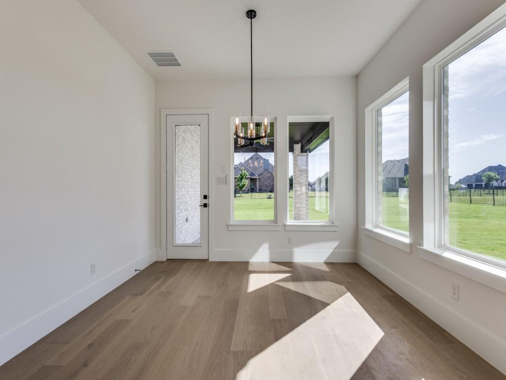 1045 Bent Tree Lane Gunter, TX 75058 - Photo 10 of 25 a view of an empty room with wooden floor and a window