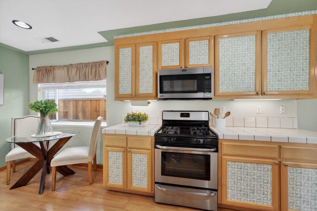 9336 Lariat Drive Gilroy, CA 95020 - Photo 14 of 41 a kitchen with a stove a sink and a microwave