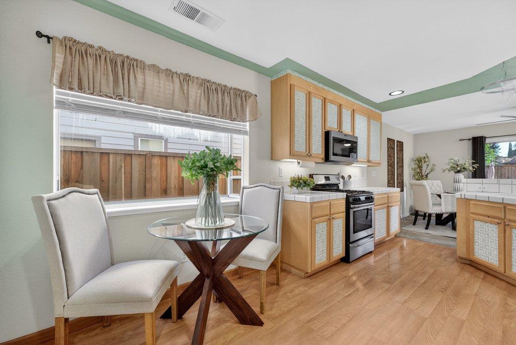 9336 Lariat Drive Gilroy, CA 95020 - Photo 15 of 41 a living room with furniture a fireplace and a flat screen tv