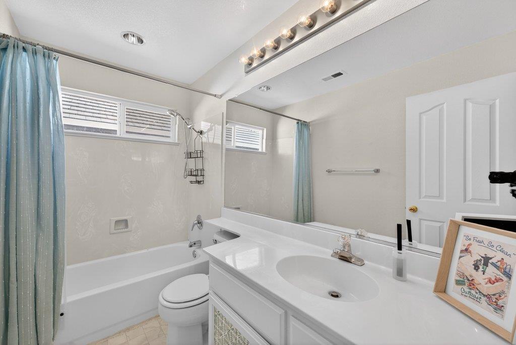 9336 Lariat Drive Gilroy, CA 95020 - Photo 27 of 41 a bathroom with a bathtub shower sink vanity mirror and toilet